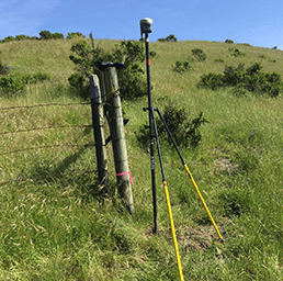 Surveying Equipment Near A Fence