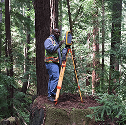 Man Holding a Surveyor Equipment